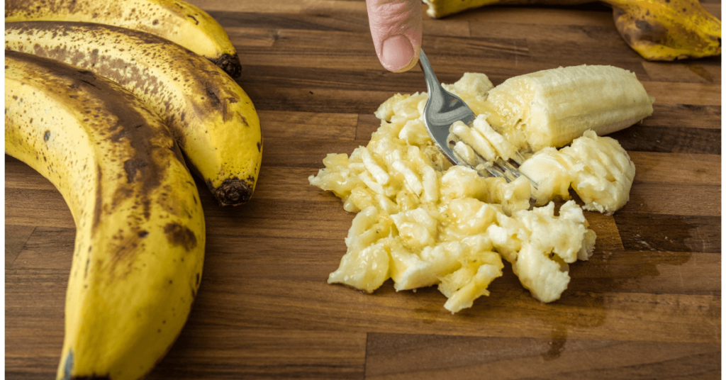 ripe bananas being mashed with a fork