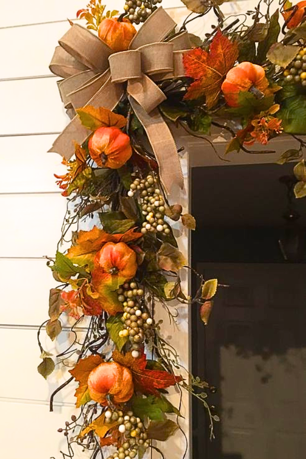 garland of pumpkins and leaves around door