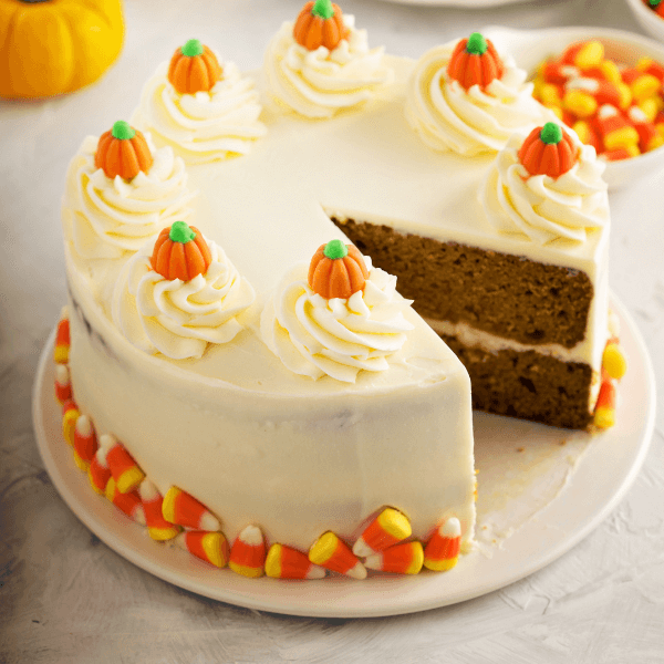 A pumpkin and yellow cake mix recipe a cake decorated with pumpkins and candy corn.