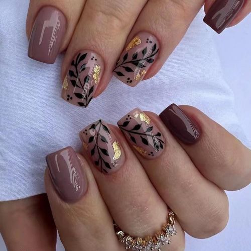 mauve nails with green leaves and gold flecks