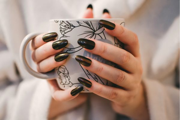 funny nail quotes A girl with painted nails holding a mug