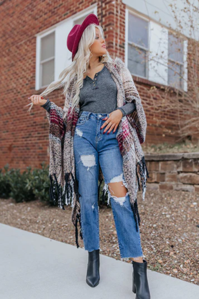 distressed jeans and boots outfit