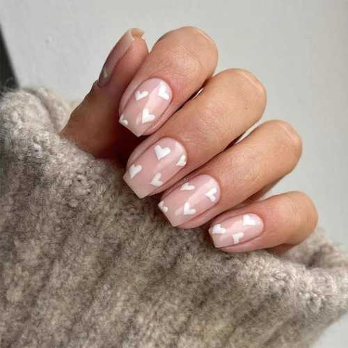 light pink nails with white hearts